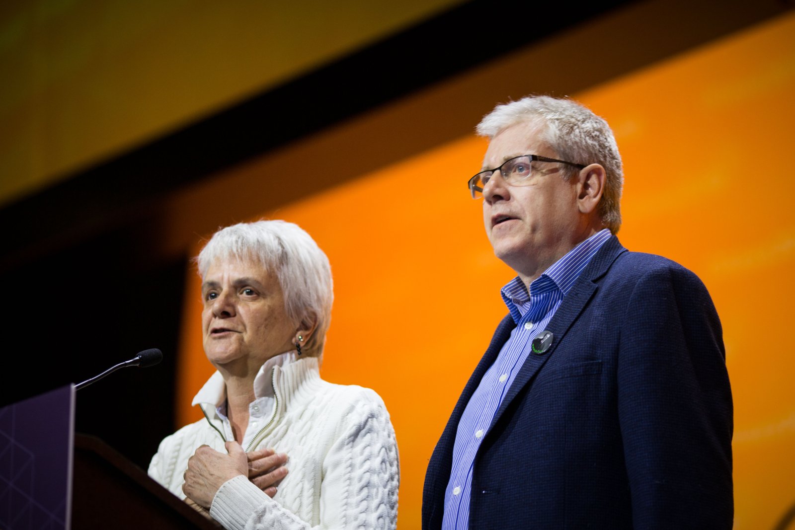 NDP MPs Charlie Angus and Helene Laverdiere speak to NDP delegates about Paul Dewar's brain cancer diagnosis in Ottawa on Feb. 17, 2018. Photo by Alex Tétreault