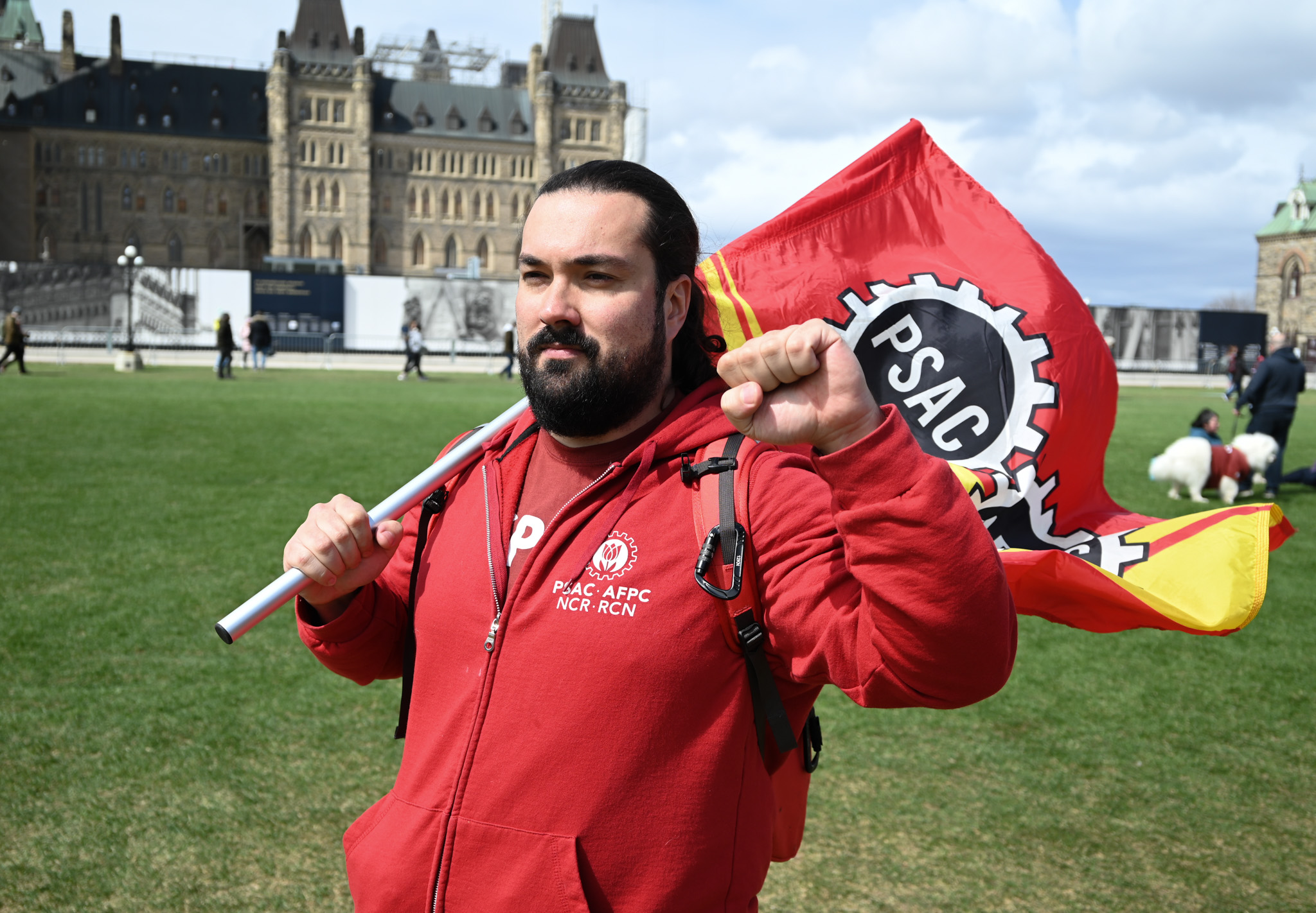 A man with a megaphone poses for a photo at Parliament Hill