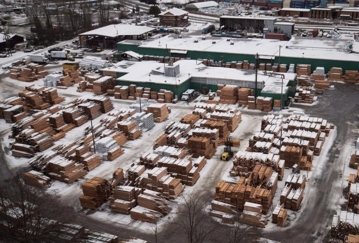 A worker uses a forklift to move lumber at Delta Cedar Products in Delta, B.C., on Friday January 6, 2017