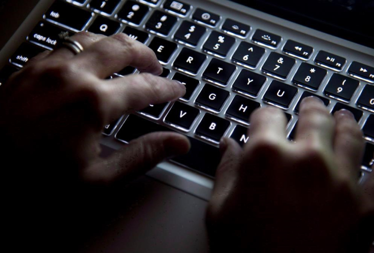 A woman uses her computer keyboard to type while surfing the internet in North Vancouver, B.C., on Wednesday, December 19, 2012.