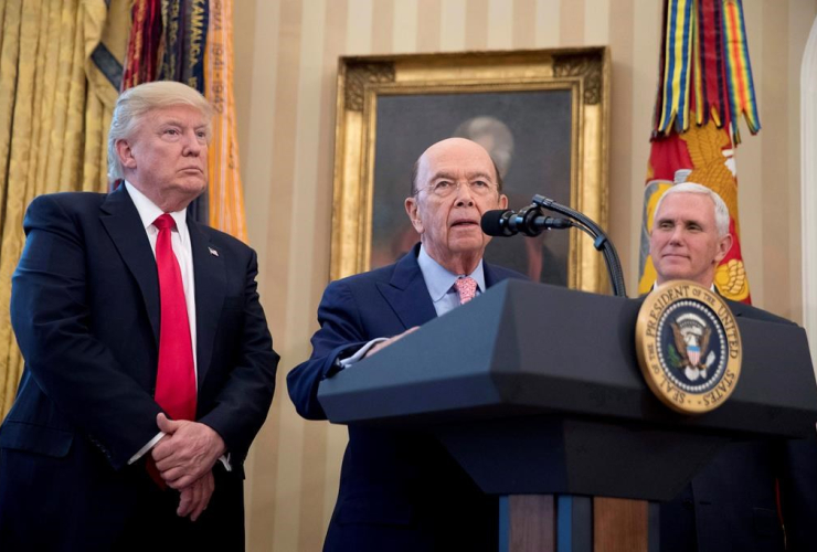 Wilbur Ross, center, accompanied by President Donald Trump, left, and Vice President Mike Pence, right, speaks during a signing ceremony for executive orders regarding trade in the Oval Office at the White House, Friday, March 31, 2017, in Washington.