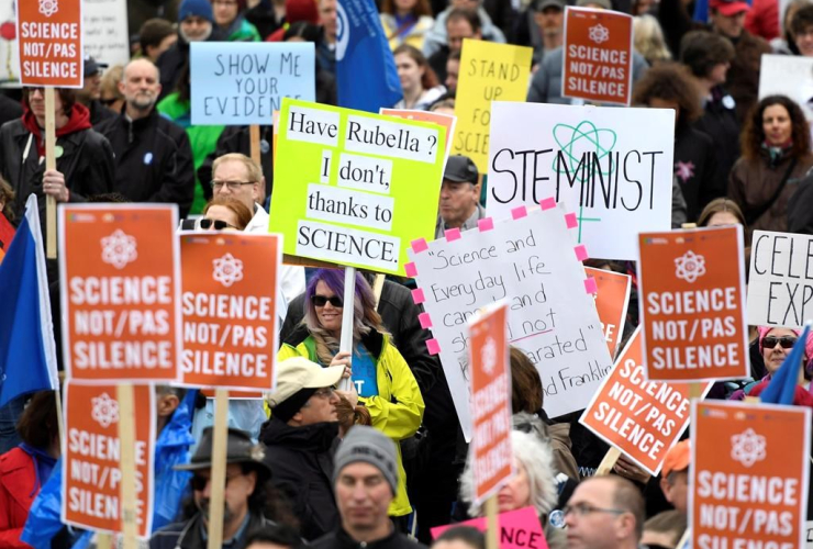 People participate in the March for Science on Parliament Hill in Ottawa, part of a global gathering to promote and advocate for science on Earth Day, Saturday, April 22, 2017.