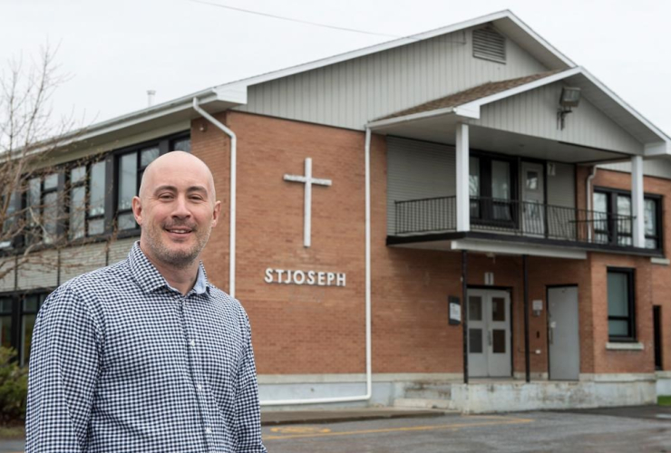 Martin Thibert, mayor of Saint-Sebastien, is seen in front of the St-Joseph school Friday, April 21, 2017 in Saint-Sebastien, Que.