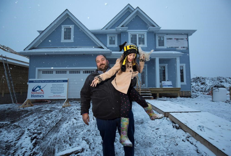 Chris Flett and his daughterJessica are shown at his new Beacon Hill house after it was rebuilt after losing it to the wildfires last year in Fort McMurray, Alta., Thursday, April 20, 2017. THE CANADIAN PRESS/Todd Korol