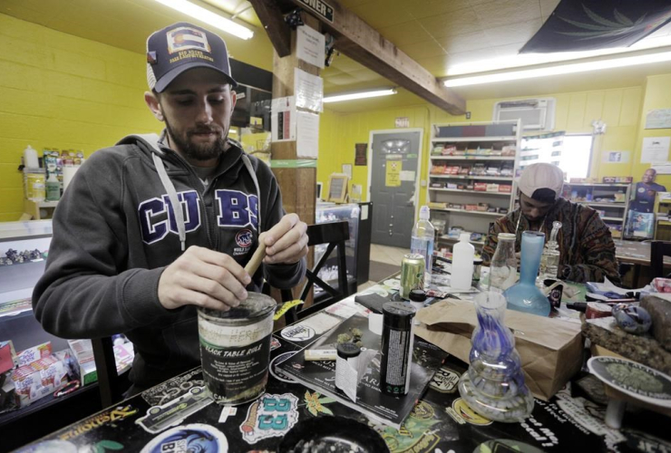 Daniel Jordan, of Tampa, Fla., left, and Giobanni Turner, St. Albans, N.Y., smoke marijuana at iBake smoking lounge on Tuesday, April 25, 2017 in Denver.