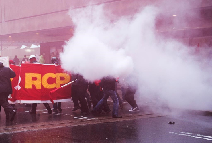 A smoke bomb goes off during a May Day demonstration Monday, May 1, 2017 in Montreal.