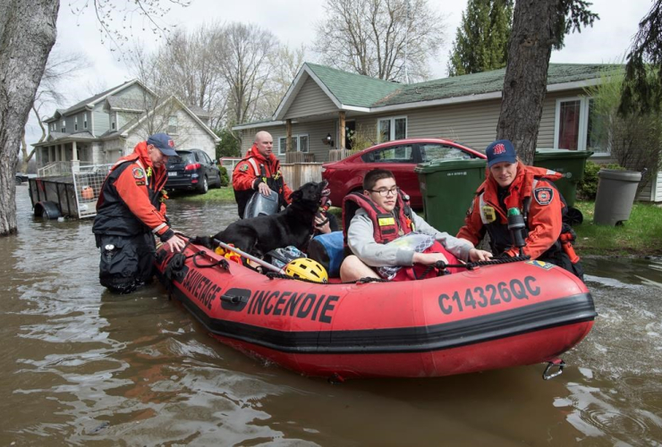 Residents are evacuated from their homes following an overnight flash flooding Wednesday, May 3, 2017 in Montreal.