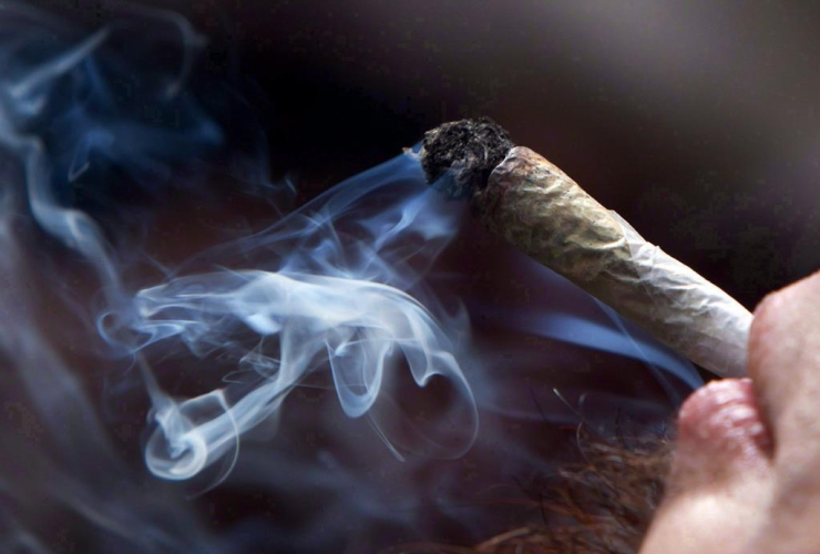 A young man smokes a marijuana joint during a rally in downtown Vancouver, B.C., on Wednesday April 20, 2011.