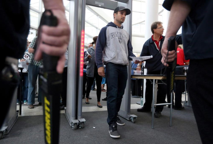 Winnipeg Jets' fan Tyler Bourassa enters through the new security measures at MTS Centre, in Winnipeg, prior to preseason hockey action versus the Minnesota Wild on Tuesday, September 22, 2015