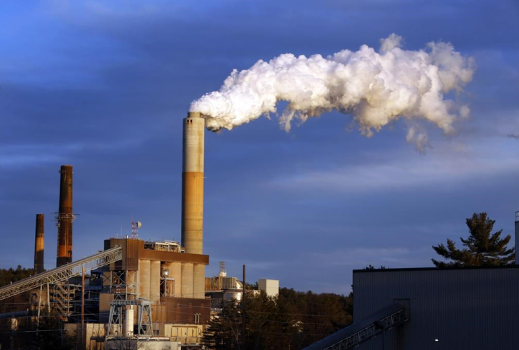 In this Jan. 20, 2015 file photo, a plume of steam billows from the coal-fired Merrimack Station in Bow, N.H.