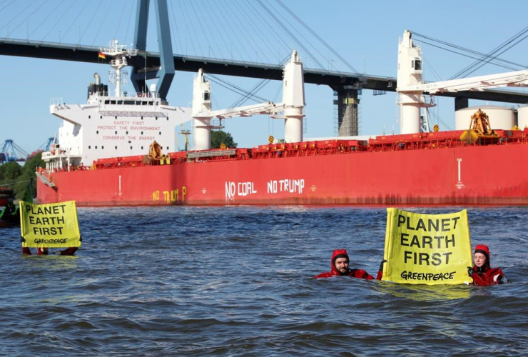 In this June 1, 2017 photo Greenpeace activists demonstrate in front of the freighter "SBI'Subaru" holding a banner with the inscription "Planet Earth First"' in Hamburg, Germany.