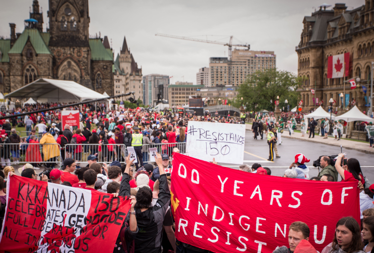 People protest during Canada 150 celebrations in Ottawa on July 1, 2017.