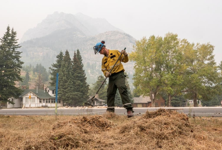 fire crew member, dead grass, Waterton, Alta. 