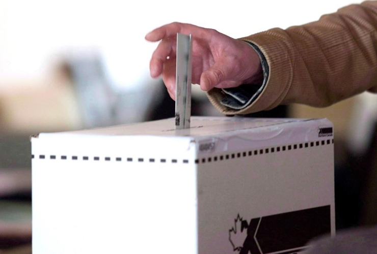 man, casts, vote, federal election, Toronto,