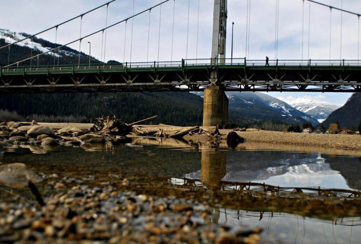 man, crosses, bridge, Columbia River, Revelstoke,