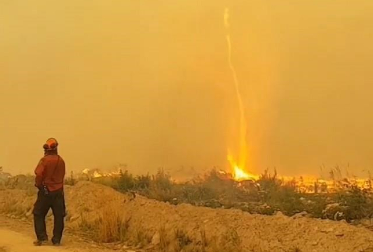 In the video posted to Instagram by firefighter Mary Schidlowsky, three crew members can be seen in a tug of war against what she calls a "fire tornado," which is sucking a hose skyward like a kite string.