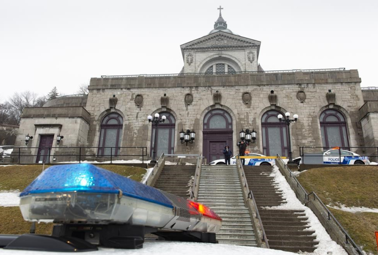 Police cars surround the St. Joesph's Oratory in Montreal on Friday, March 22, 2019. A Catholic priest was stabbed as he was celebrating mass this morning at the Oratory.