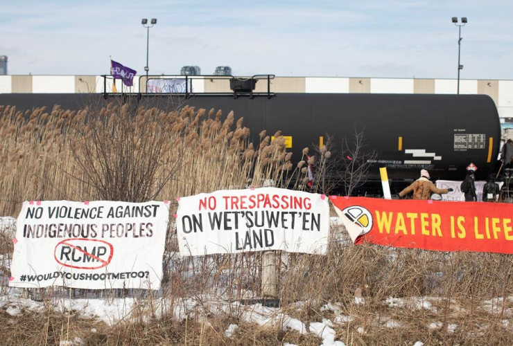 Banners, protesters, blockade, rail line, Macmillan Yard, Toronto, 