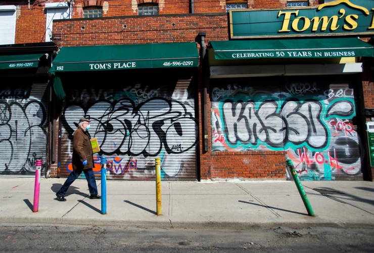 person, walks, closed businesses, Kensington Market, Toronto,