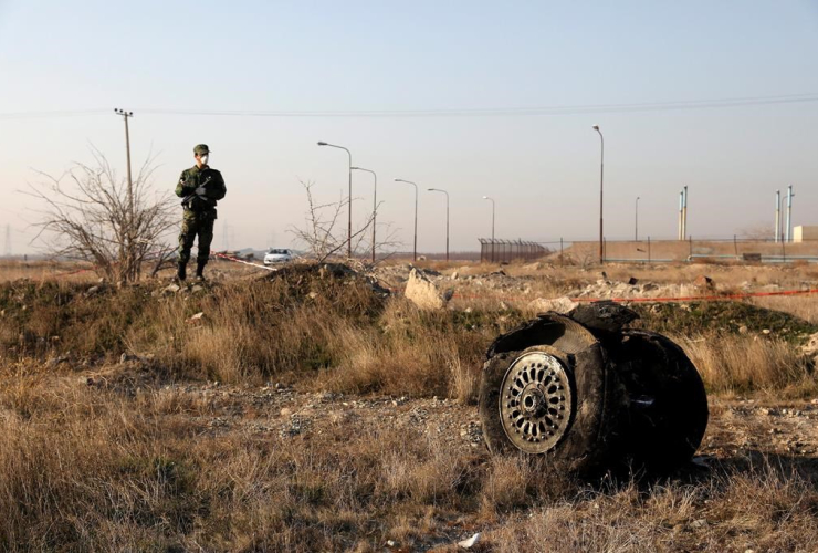 police officer, guard, debris, Ukrainian plane, crashed, Shahedshahr, Tehran, Iran, 