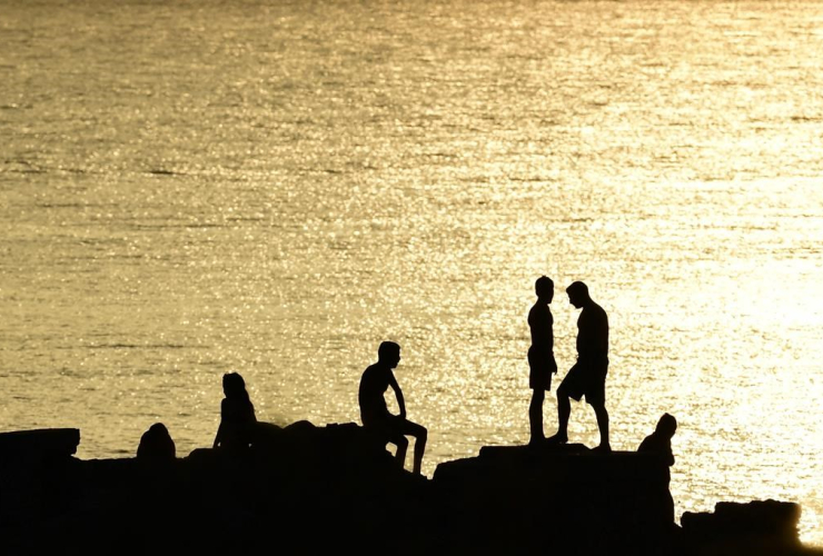 People, rocks, beach, Kavouri, Athens, Greece,