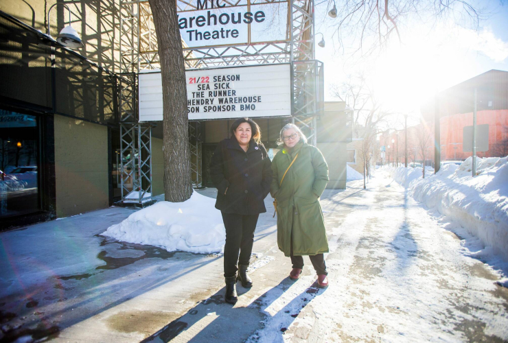 Two women standing outside a theatre