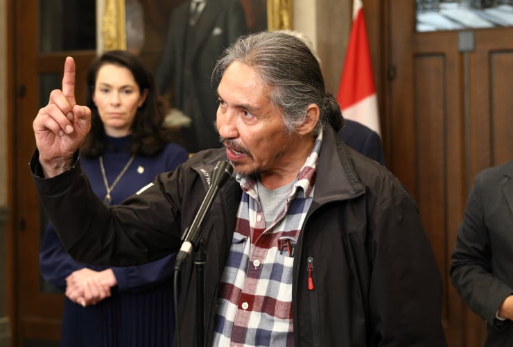 ACFN Chief Allan adam stands, gesturing emphatically with his hand while speaking at a press conference in Ottawa last year