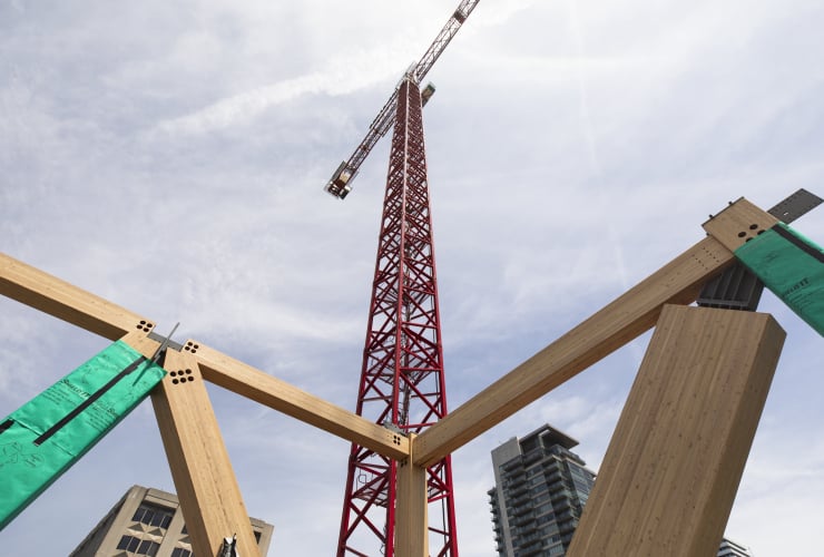 A construction crane towers over the Academic Wood Tower construction site on the University of Toronto campus. Toronto, Ont.