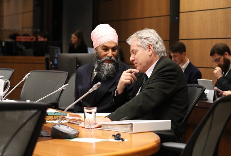 Jagmeet Singh and charlie Angus speak before a committee meeting