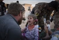 Young children are treated at a first-aid station in the Gogjali neighbourhood of Eastern Mosul after they were injured by a mortar round