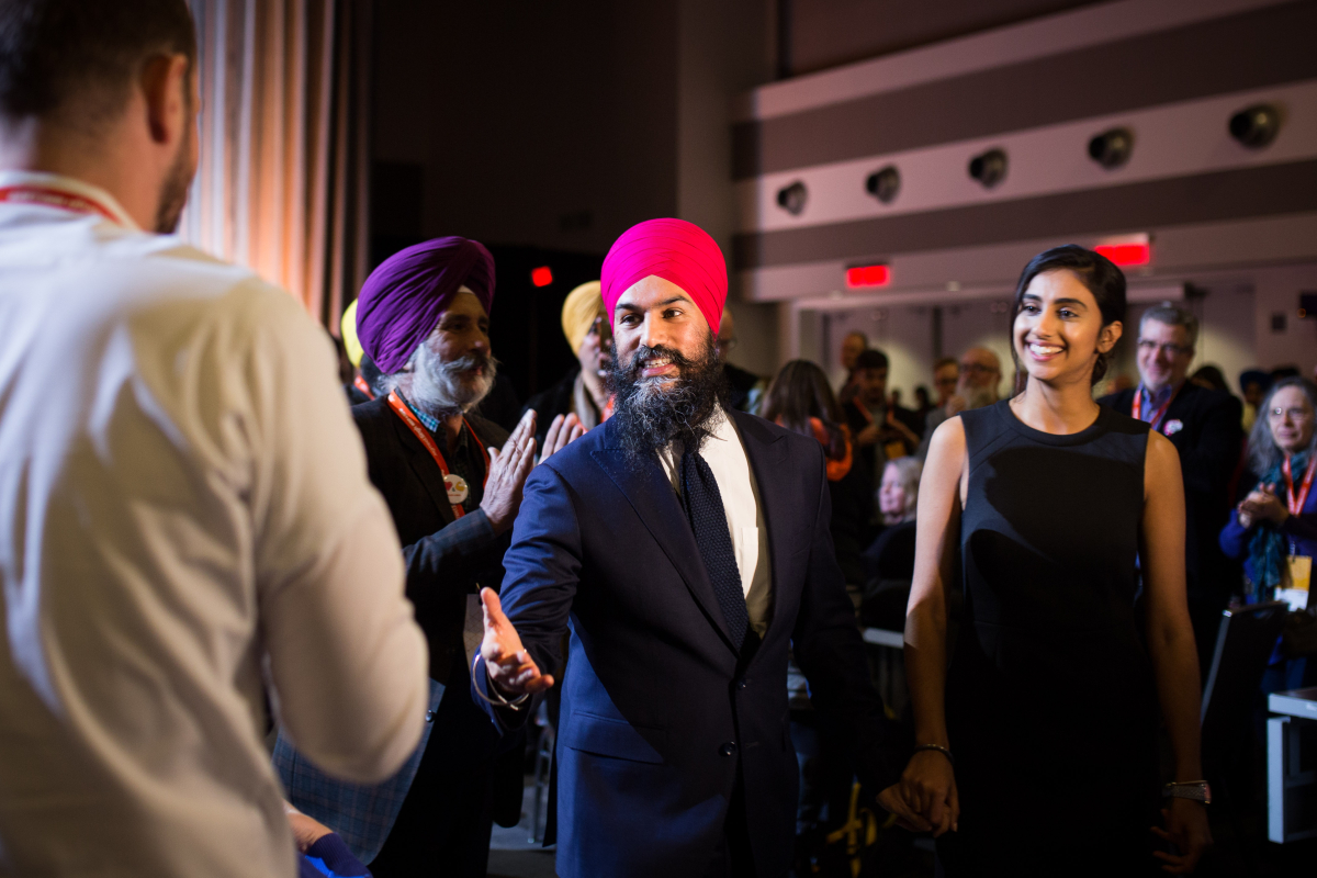 Jagmeet Singh reaches out to delegates as he leaves the NDP convention stage with his fiancée Gurkiran Kaur on Feb. 17, 2018 in Ottawa. Photo by Alex Tétreault