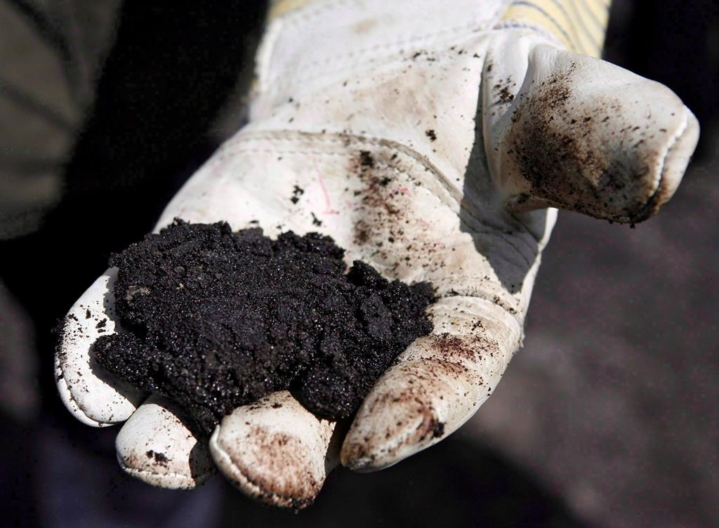 oil worker, raw sand bitumen, Fort McMurray, 