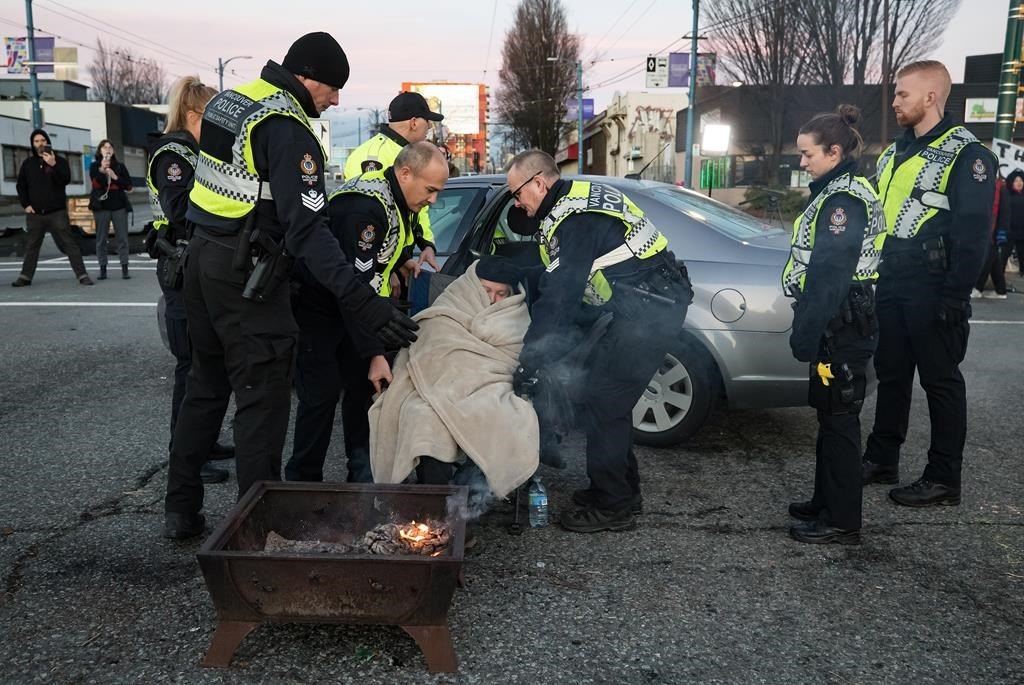 Police officers, elderly woman, protesters, Wet'suwet'en hereditary chiefs,