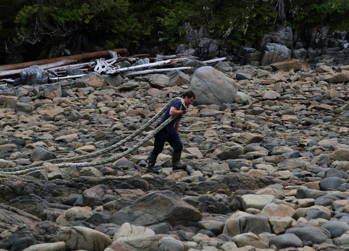 A crew member drags a long mooring rope off a beach on B.C.'s central coast as part of a marine debris recovery expedition