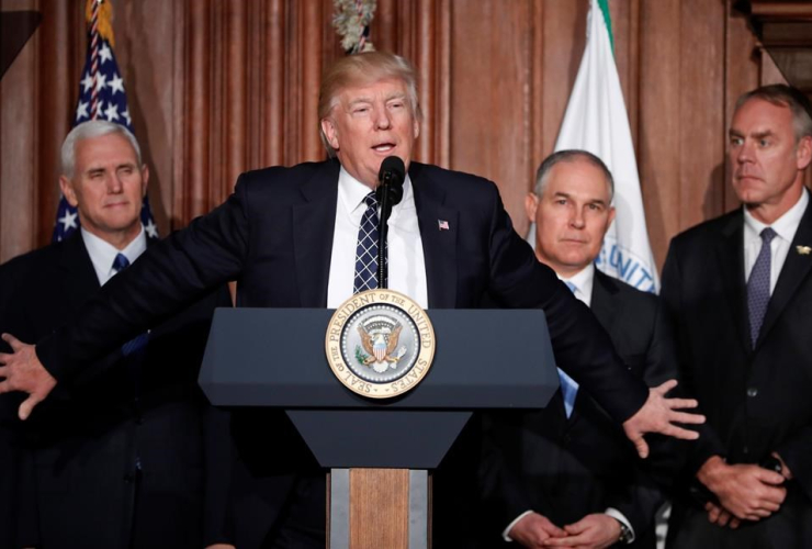 President Donald Trump, accompanied by from left, Mike Pence, Scott Pruitt, and  Ryan Zinke, speaks at EPA headquarters in Washington, prior to signing an Energy Independence Executive Order