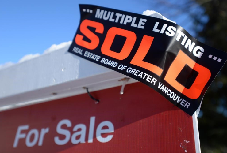 A real estate sold sign is shown outside a house in Vancouver, Tuesday, Jan.3, 2017.