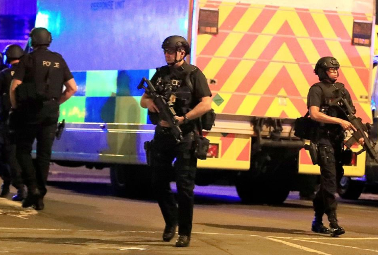 Armed police respond after reports of an explosion at Manchester Arena during an Ariana Grande concert in Manchester, England, Monday, May 22, 2017.