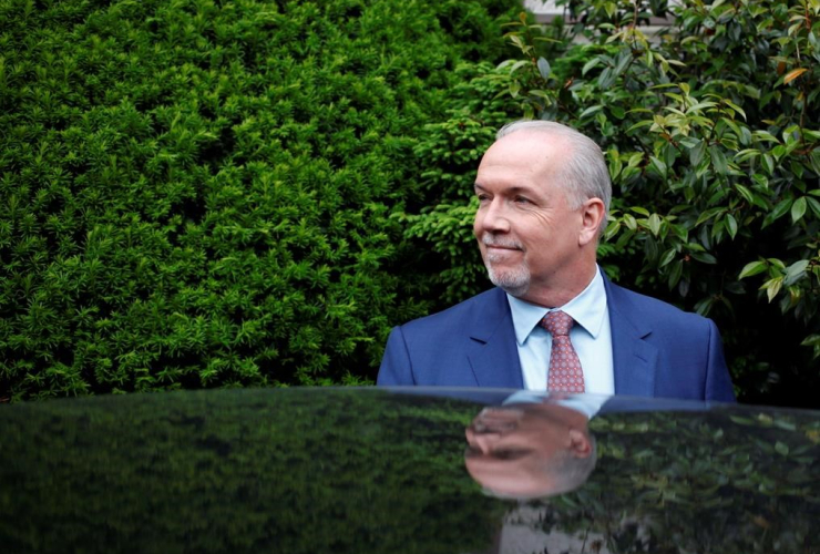 B.C. NDP leader John Horgan leaves with B.C. Green party leader Andrew Weaver from Government House after dropping of a signed document by 44 MLAs showing there is an agreement between the two parties in Victoria, B.C., on May 31, 2017.