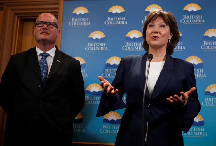 B.C. Finance Minister Michael de Jong joins Premier Christy Clark to talk with media after being sworn-in as Premier following a ceremony at Legislature in Victoria, B.C., on Thursday, June 8, 2017.